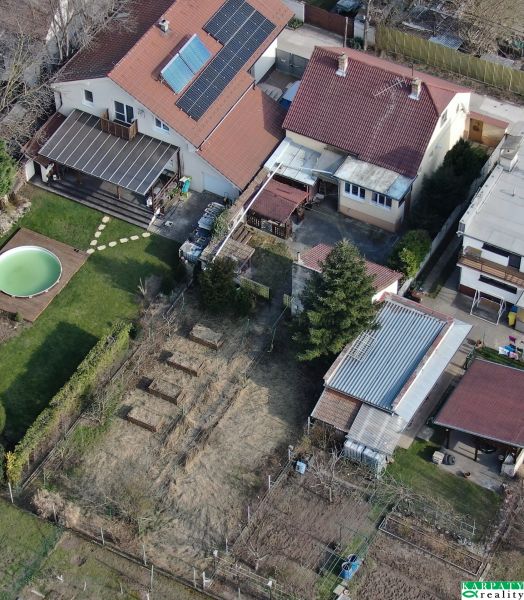 A family house in Trnava on Krajná Street with a swimming pool and a garden with raised beds.