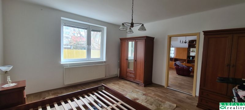 A room in a family house with furniture and a wooden decor floor.