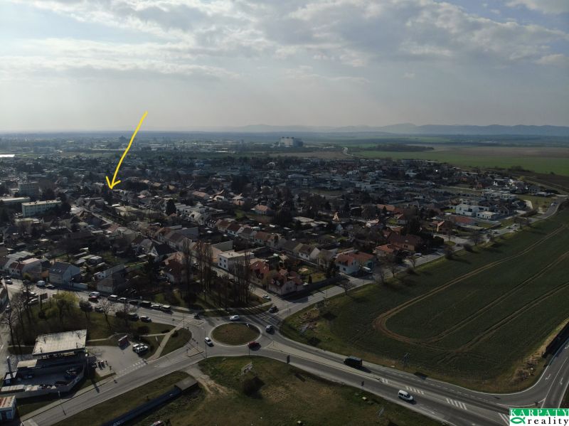 Aerial view of family houses on Krajná Street in Trnava surrounded by greenery.
