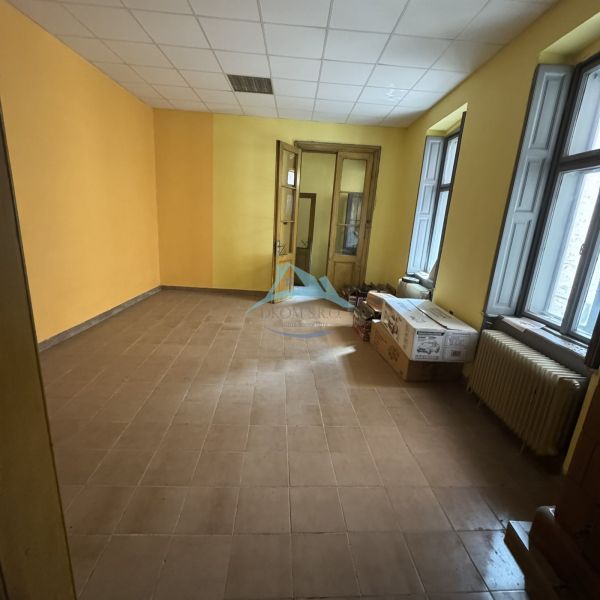 Yellow walls, tiles, large windows, cardboard boxes in commercial spaces.