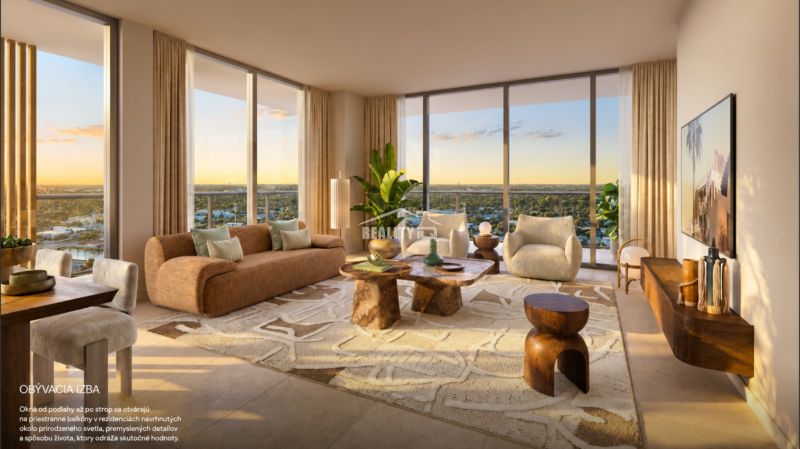 Bright living room with large windows, comfortable seating, and a carpet.