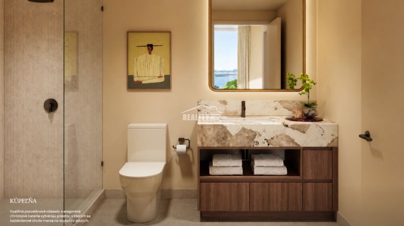 A bathroom in a studio apartment with a marble sink and a glass shower enclosure.