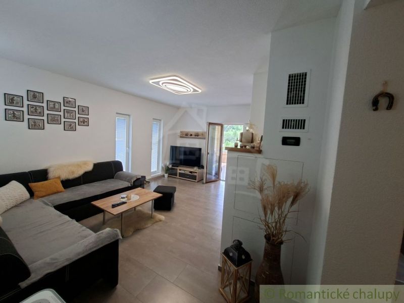 Living room in a family house with a corner sofa and a wooden decor floor.