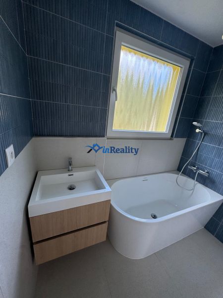 The bathroom includes a bathtub, a sink, and a window in a three-room apartment.