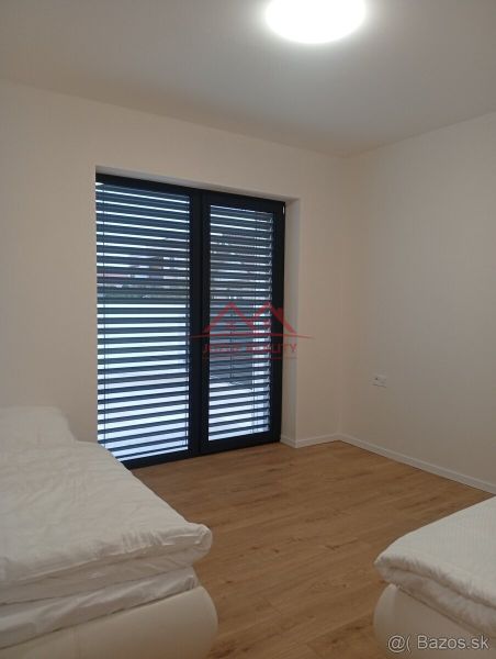 A room in a family house with a bed and a wooden decor floor.