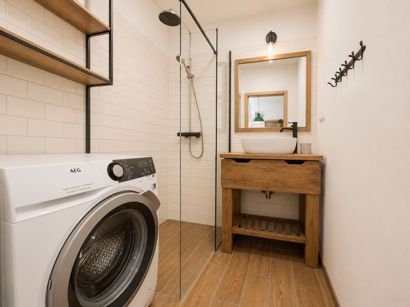 Bathroom in a 2-room apartment, washing machine, shower, sink, floor with wood decor.