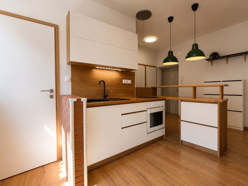 A kitchen with wooden decor in a 2-room apartment, kitchen unit with a black sink.