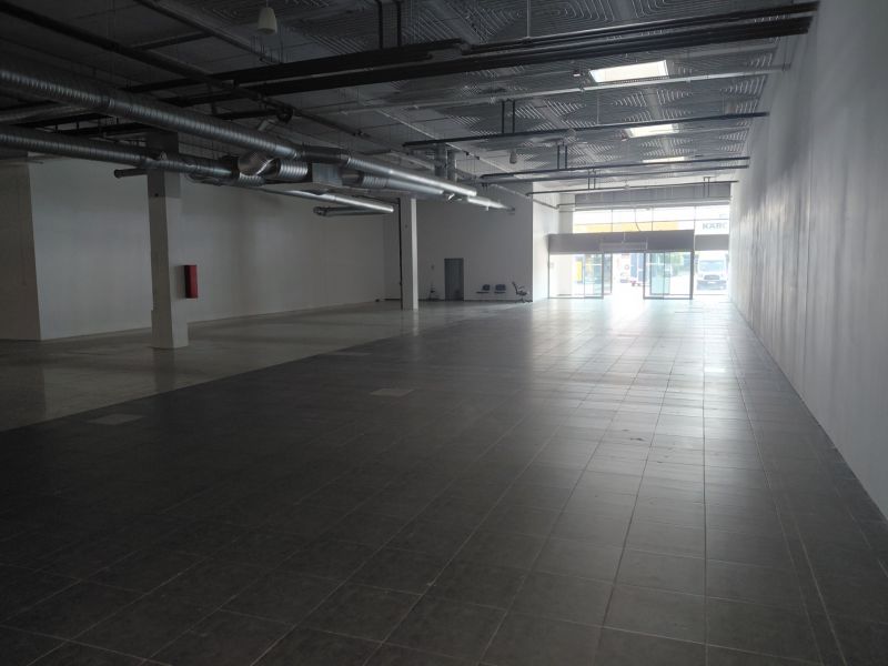 Spacious commercial spaces with large windows and high ceilings.