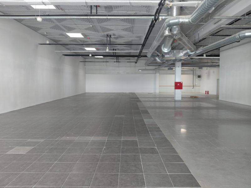 Commercial premises with gray tiles and spacious interior, suitable for construction in Bratislava.