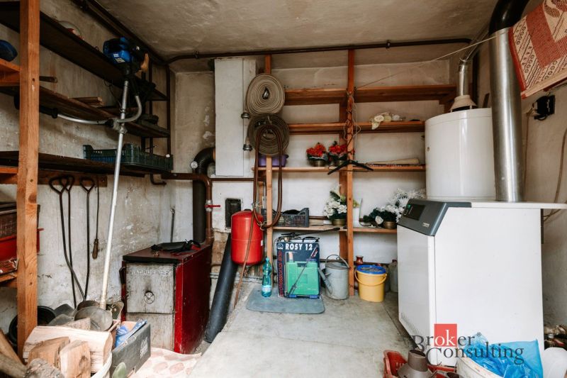Boiler room with shelves and equipment in a family house.