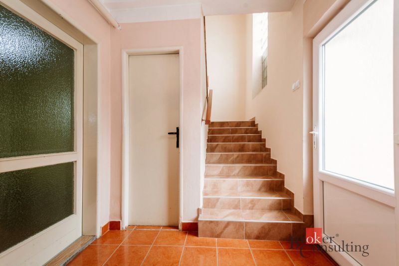 Interior with ceramic flooring and staircase in a family house.