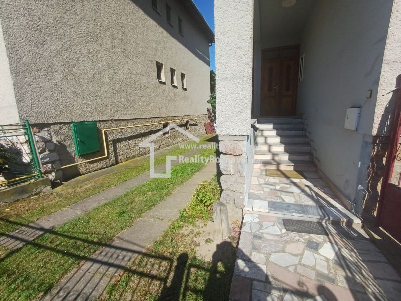 Entrance to a family house in Rožňava with stairs and a paved terrace.