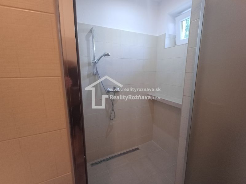 Shower enclosure with ceramic tiles in a family house.