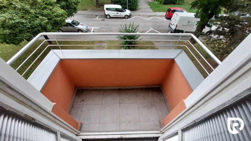 A balcony from a 2-room apartment on 28. októbra Street in Trenčín with a view of the street.