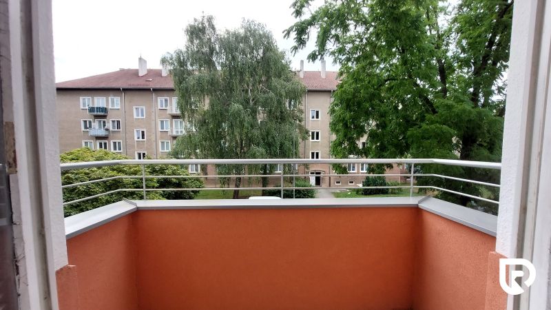 The balcony of a 2-room apartment on 28. októbra Street in Trenčín with a view of greenery.