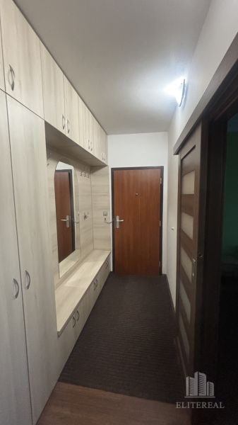 Entrance hallway in a 3-room apartment with wooden decor and storage space.