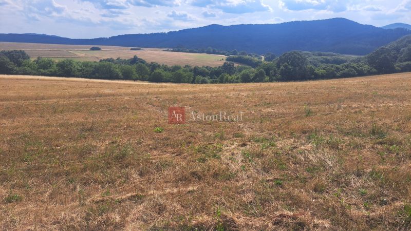 Extensive residential plots in Ostrá Lúka surrounded by green hills and meadows.