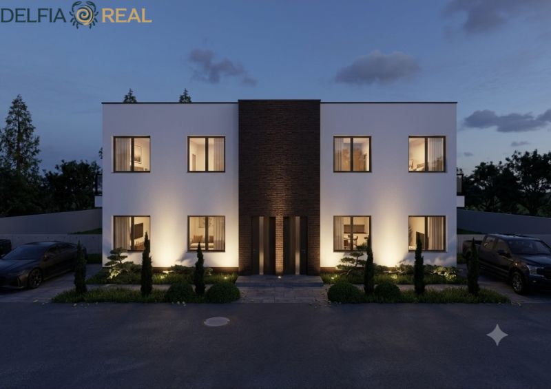 Illuminated facade of a two-story house with a symmetrical design in the village of Veľká Mača.