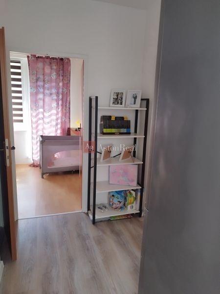 Interior of a 2-room apartment with a shelf and a wooden decor floor.
