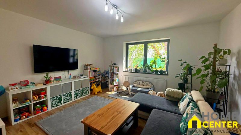 Living room in a family house with a large window and a wooden decor floor.
