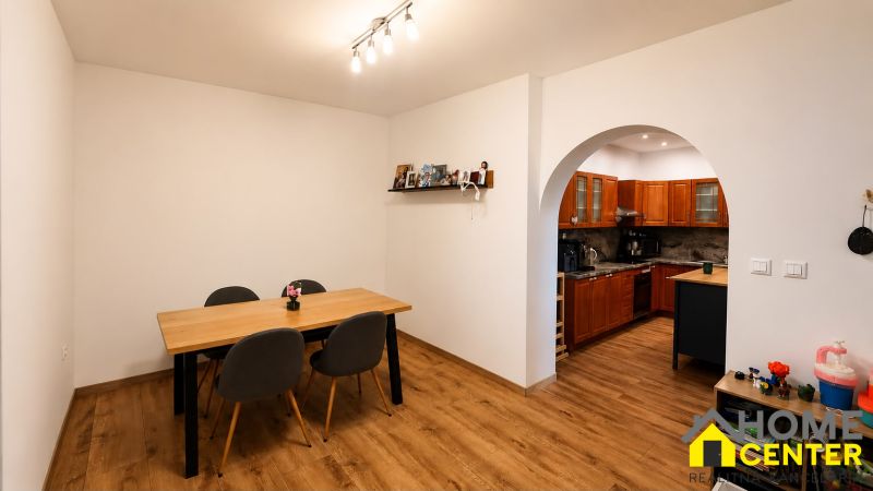 Dining room and kitchen in a family house with a wooden decor floor.