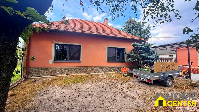 A family house in Iža with a spacious yard and a carport.