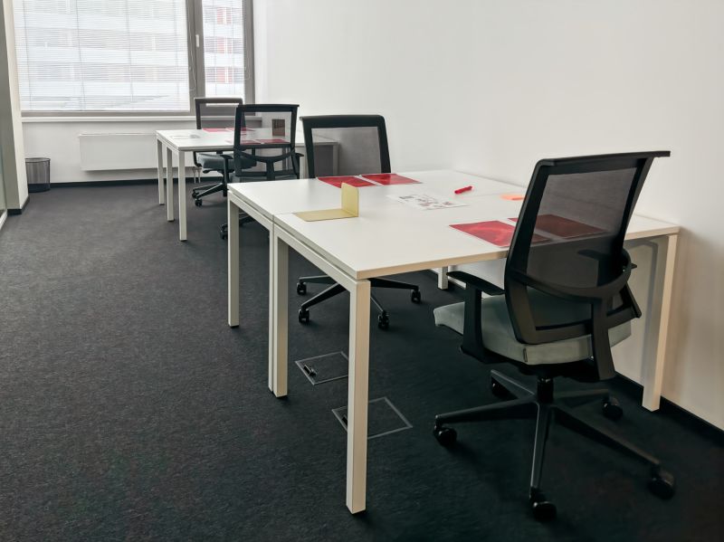Offices with desks and chairs, ready for work.