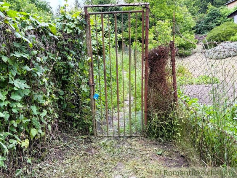 A rustic gate leads to the garden at the cottage in Bratislava IV.