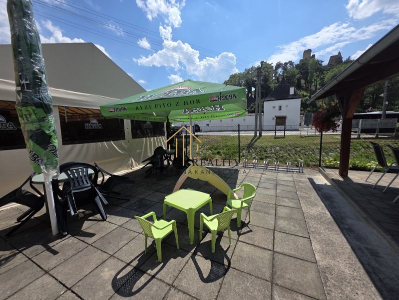 Exterior of commercial premises in Divín, terrace with a sunshade and children's corner.