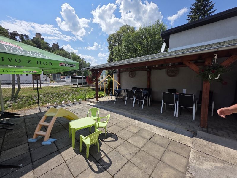 In Divín, there are commercial spaces with a garden seating area and a children's playground.