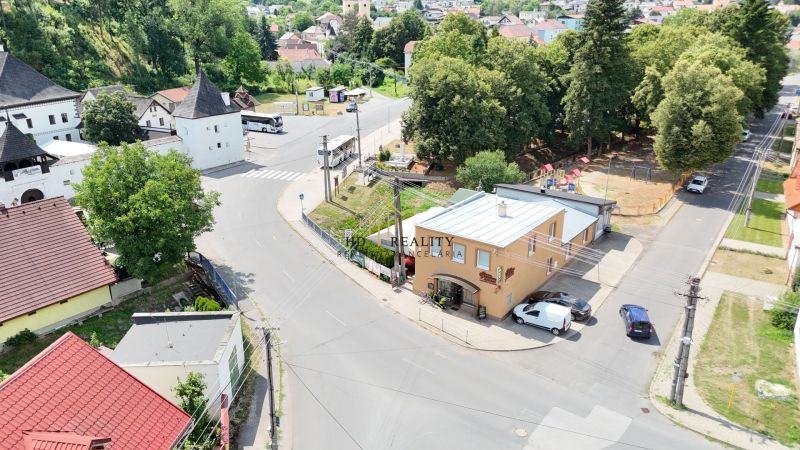 Aerial view of commercial premises in Divín surrounded by greenery and historic buildings.