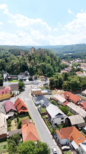 Aerial view of the ruins of the castle and houses in Divín, commercial spaces in the foreground.