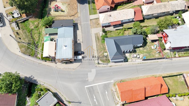 Aerial view of commercial premises in Divín with adjacent roads and greenery.