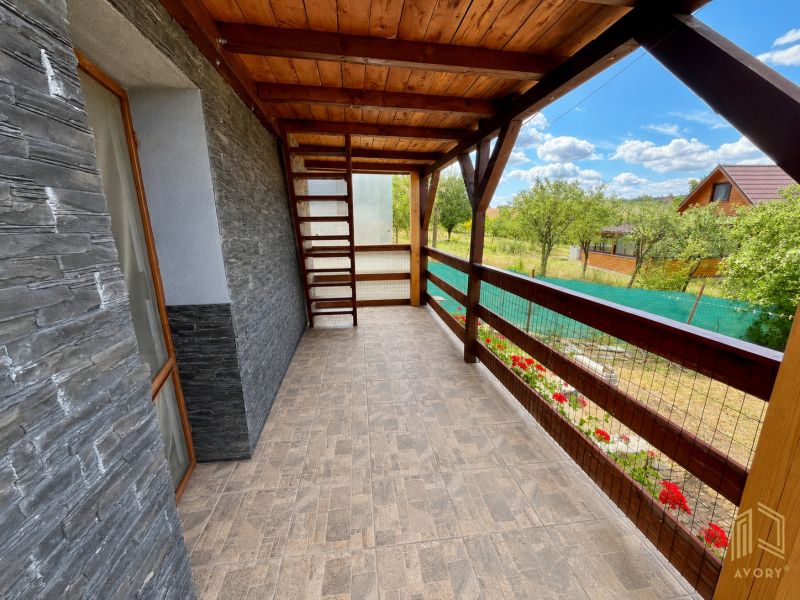 Veranda of the cottage in Skalica with a view of the garden and stone walls.