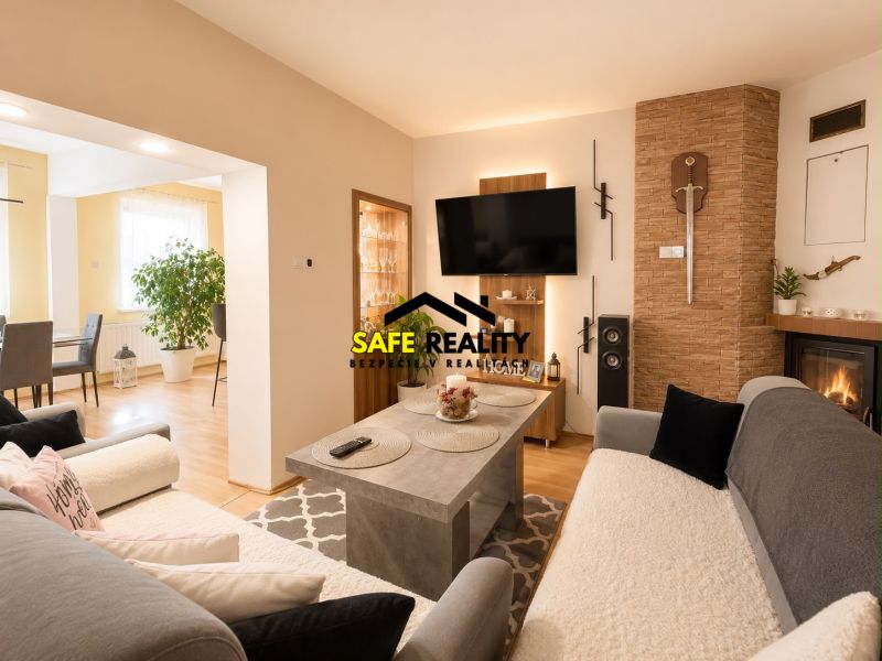 Interior of a family house with a wooden decor floor, fireplace, and comfortable seating.