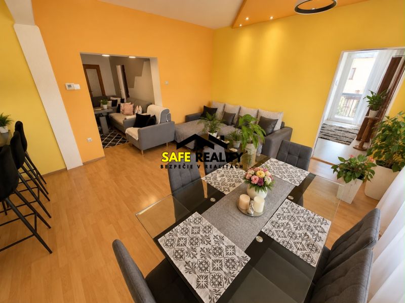 Colorful interior of a family house with a sofa and a dining table, floor with wooden decor.