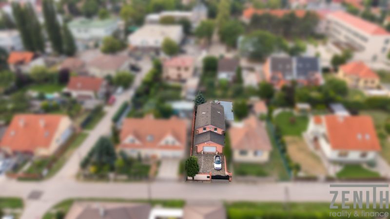 A family house in Bernolákovo with a parking lot and a garden, surrounded by other houses.