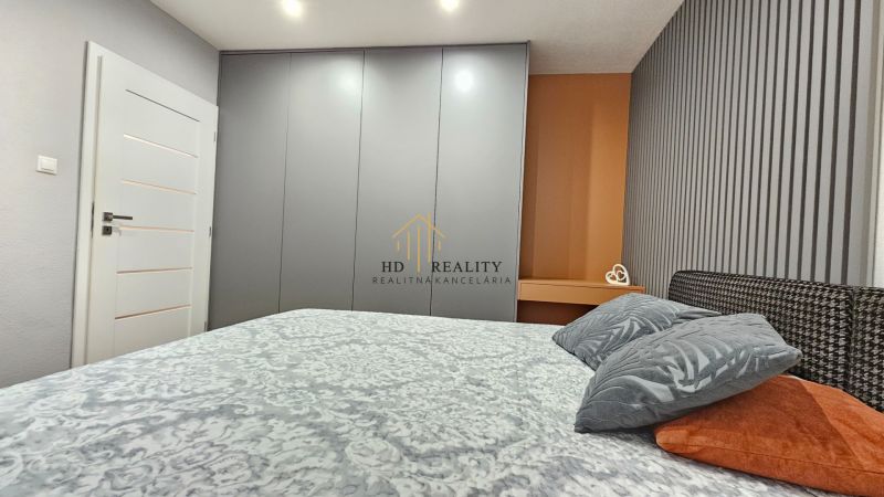Bedroom in a 2-room apartment with a large wardrobe and decorative accessories.