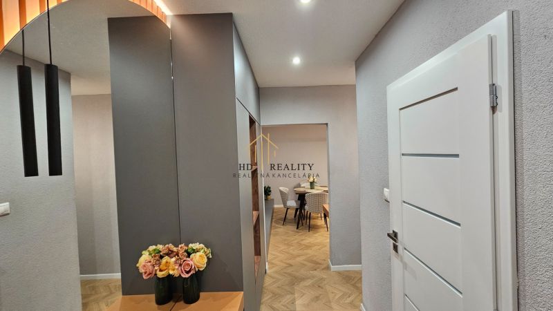 Interior of a 2-room apartment with a wooden decor floor and elegant details.
