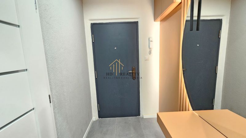 Entrance hallway of a 2-room apartment with steel doors and light walls.