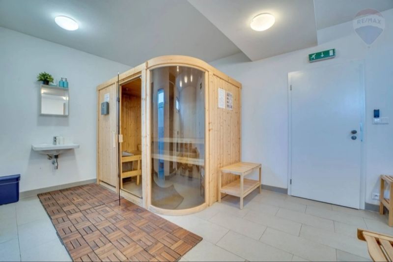 A sauna with a wooden decor floor in a 2-room apartment.