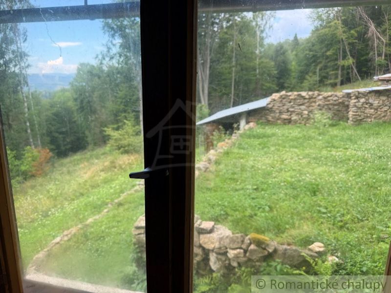 View from the family house in Kokava nad Rimavicou of stone walls and greenery.
