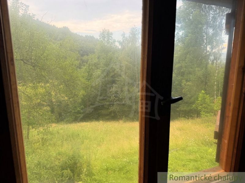 View from a family house in Kokava nad Rimavicou of green trees and meadows.