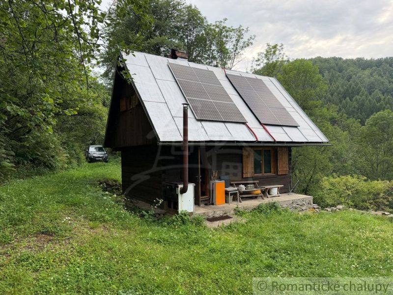 A family house in Kokava nad Rimavicou surrounded by nature, with solar panels on the roof.
