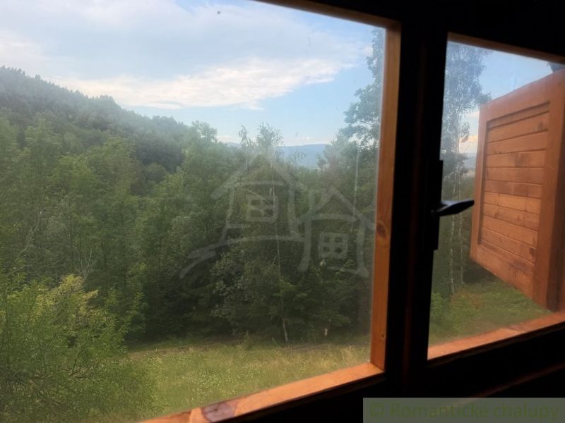 A view from the window of a family house to greenery and hills in Kokava nad Rimavicou.