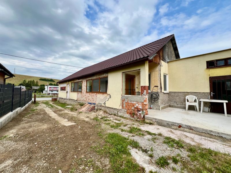 A family house in Ľubotín with an unfinished facade and a concrete terrace.