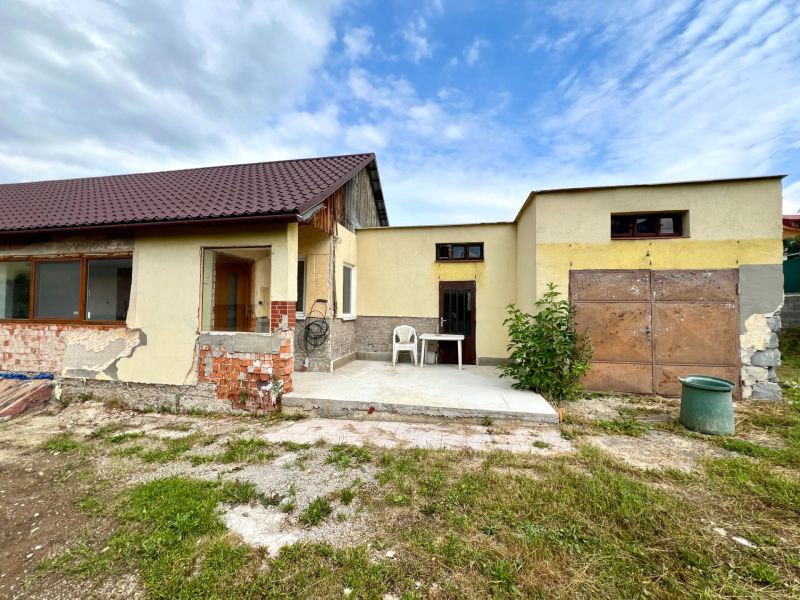 A family house in Ľubotín with a hallway, garage, and unfinished facade.