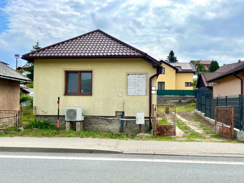 A family house in the village of Ľubotín with a gable roof and a fenced yard.