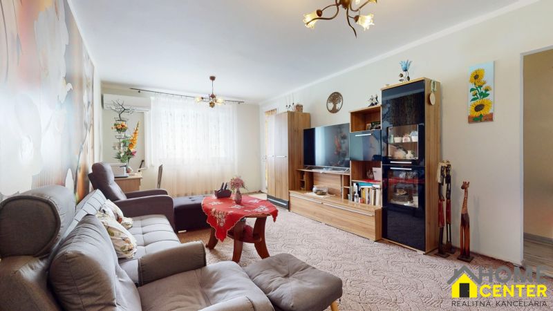 Living room in a 3-room apartment with a comfortable sofa and a decorative wall.