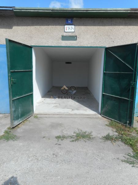 Open garages on Ľudovíta Stárka in Trenčín, with an empty interior and concrete floor.